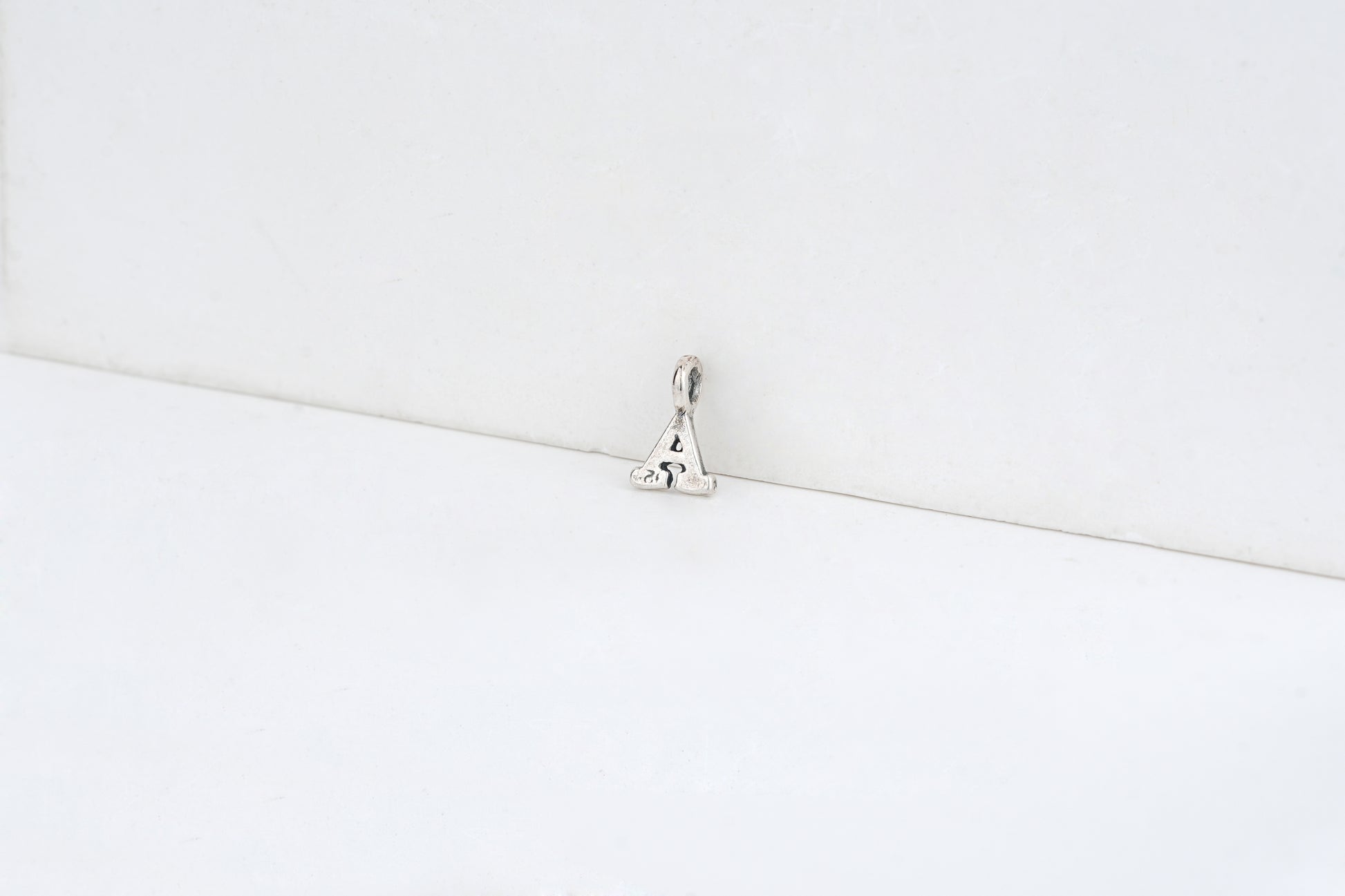 a - detail shot - English letter charm | Love Letters Tel Aviv